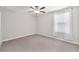 Neutral bedroom featuring gray carpet, light walls, and a window with white curtains at 12715 Maple Bonsai Dr, Riverview, FL 33579
