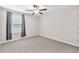 Neutral bedroom featuring gray carpet, light walls, and a window with gray curtains at 12715 Maple Bonsai Dr, Riverview, FL 33579