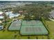 Aerial shot of community amenities including pools, tennis courts, and a basketball court, set among lush greenery at 12715 Maple Bonsai Dr, Riverview, FL 33579