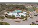 Aerial view of the community center, pool, and amenities surrounded by landscaping, and lush trees at 12715 Maple Bonsai Dr, Riverview, FL 33579