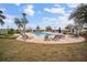 Inviting community pool featuring ample seating for residents and visitors to enjoy leisure time outdoors at 12715 Maple Bonsai Dr, Riverview, FL 33579
