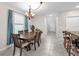 Dining area with elegant chandelier and view into the adjacent hallway and kitchen at 12715 Maple Bonsai Dr, Riverview, FL 33579