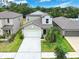 Charming home with manicured front yard, lush landscaping, and a welcoming two-car garage at 12715 Maple Bonsai Dr, Riverview, FL 33579