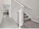 Inviting hallway features tile flooring and a staircase with carpeted steps at 12715 Maple Bonsai Dr, Riverview, FL 33579