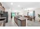 Open floorplan kitchen with stainless appliances, stone counters and view of the backyard at 12715 Maple Bonsai Dr, Riverview, FL 33579