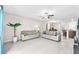 Living room flowing into dining and kitchen area, with tile floors and neutral paint at 12715 Maple Bonsai Dr, Riverview, FL 33579