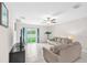 Open living area with tile floors, neutral paint, and sliding glass doors to the backyard at 12715 Maple Bonsai Dr, Riverview, FL 33579