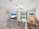 Bright living room featuring tile floors, neutral paint, and sliding glass doors to the backyard at 12715 Maple Bonsai Dr, Riverview, FL 33579