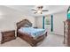 Main bedroom featuring a decorative headboard and ceiling fan at 12715 Maple Bonsai Dr, Riverview, FL 33579