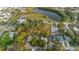 An aerial view showing the neighborhood, lush greenery, and tranquil lake at 138 69Th N Ave, St Petersburg, FL 33702