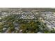 An aerial view showcases the community near a lake and surrounding neighborhood at 138 69Th N Ave, St Petersburg, FL 33702
