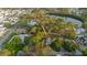 Aerial view of a charming home near a serene lake, surrounded by lush trees at 138 69Th N Ave, St Petersburg, FL 33702