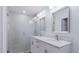 Stylish bathroom featuring a double sink vanity, modern lighting, and a glass-enclosed shower at 138 69Th N Ave, St Petersburg, FL 33702