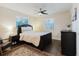Comfortable bedroom featuring a padded headboard, ceiling fan, and a warm, inviting ambiance at 138 69Th N Ave, St Petersburg, FL 33702