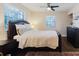 Comfortable bedroom featuring a padded headboard, ceiling fan, and a warm, inviting ambiance at 138 69Th N Ave, St Petersburg, FL 33702