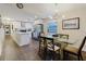Dining area with a glass table, and an open layout connects to the modern kitchen and laundry room at 138 69Th N Ave, St Petersburg, FL 33702