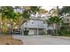 Charming two-story home with a gray exterior, carport, and well-maintained landscaping at 138 69Th N Ave, St Petersburg, FL 33702