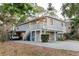Charming two-story home with a raised foundation, inviting staircase, and convenient covered parking area at 138 69Th N Ave, St Petersburg, FL 33702