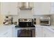 Modern kitchen with stainless steel appliances, white cabinets, and granite countertops at 138 69Th N Ave, St Petersburg, FL 33702
