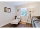 Cozy living room nook featuring a chair, ottoman, and floor lamp, creating a relaxing reading area at 138 69Th N Ave, St Petersburg, FL 33702