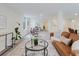 Open living area with wood-look floors, a modern leather couch, and lots of natural light at 138 69Th N Ave, St Petersburg, FL 33702
