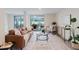 Inviting living room featuring a stylish leather couch and sliding glass doors to a patio at 138 69Th N Ave, St Petersburg, FL 33702