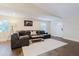 Comfortable living room featuring a stylish leather sectional sofa, modern decor, and ample natural light from the windows at 138 69Th N Ave, St Petersburg, FL 33702