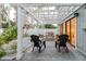 Cozy outdoor patio with wicker furniture and white pergola, ideal for relaxation at 138 69Th N Ave, St Petersburg, FL 33702