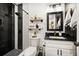 Modern bathroom features black and white tiled shower, floating shelves, and updated fixtures at 14 S Meteor Ave, Clearwater, FL 33765