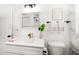 Updated bathroom with modern vanity, stylish mirror, and marble tiled shower at 14 S Meteor Ave, Clearwater, FL 33765