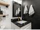 Modern bathroom with black accent wall, marble counter, and contemporary fixtures at 14 S Meteor Ave, Clearwater, FL 33765