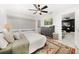 Cozy bedroom featuring neutral colors, a ceiling fan, and an area rug at 14 S Meteor Ave, Clearwater, FL 33765