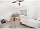 Well-lit bedroom with a unique ceiling fan, play tent, and plush armchair at 14 S Meteor Ave, Clearwater, FL 33765