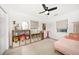 Bright bedroom with hardwood flooring, a ceiling fan, and closet shelving at 14 S Meteor Ave, Clearwater, FL 33765