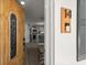 Open entryway features a modern wood door, clear view into the kitchen and a home security doorbell at 14 S Meteor Ave, Clearwater, FL 33765