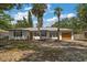 Attractive single-story home featuring a well maintained lawn, a 1-car garage and mature trees at 14 S Meteor Ave, Clearwater, FL 33765