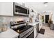 Well-appointed kitchen with stainless steel appliances, marble backsplash, and ample counter space at 14 S Meteor Ave, Clearwater, FL 33765