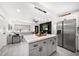 Spacious kitchen and living area with a large island and stainless steel refrigerator at 14 S Meteor Ave, Clearwater, FL 33765