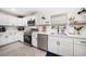 Bright kitchen features white cabinets, stainless steel appliances, and a modern backsplash at 14 S Meteor Ave, Clearwater, FL 33765