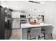 Elegant kitchen featuring an island with bar seating, pendant lighting, and stainless appliances at 14 S Meteor Ave, Clearwater, FL 33765