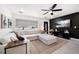 Inviting living room boasts an oversized sectional couch, modern ceiling fan, and a sleek black accent wall at 14 S Meteor Ave, Clearwater, FL 33765