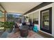 Cozy covered patio with stylish furniture, plants, and modern privacy screen at 14 S Meteor Ave, Clearwater, FL 33765