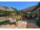 Cozy covered patio with comfortable seating, a decorative privacy screen, and a stylish egg chair at 14 S Meteor Ave, Clearwater, FL 33765