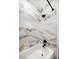 Shower with stylish marble tile surround and black shower fixture at 14 S Meteor Ave, Clearwater, FL 33765