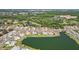 Scenic aerial view of waterfront homes with lush landscaping, golf course and beautiful ponds at 1405 W Del Webb Blvd, Sun City Center, FL 33573