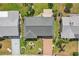 Aerial view of a well-maintained property showcasing the roof, driveway, and landscaping at 1405 W Del Webb Blvd, Sun City Center, FL 33573