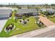 Aerial view of home featuring manicured landscaping, brick driveway, and a partial lake view at 1405 W Del Webb Blvd, Sun City Center, FL 33573