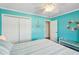 Coastal bedroom featuring two closets, ceiling fan, and ocean-themed decor at 1405 W Del Webb Blvd, Sun City Center, FL 33573
