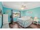 Bright bedroom with wood floors, ceiling fan, and large window at 1405 W Del Webb Blvd, Sun City Center, FL 33573
