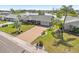 Inviting home with a well-manicured lawn, brick driveway, and partial lake view at 1405 W Del Webb Blvd, Sun City Center, FL 33573